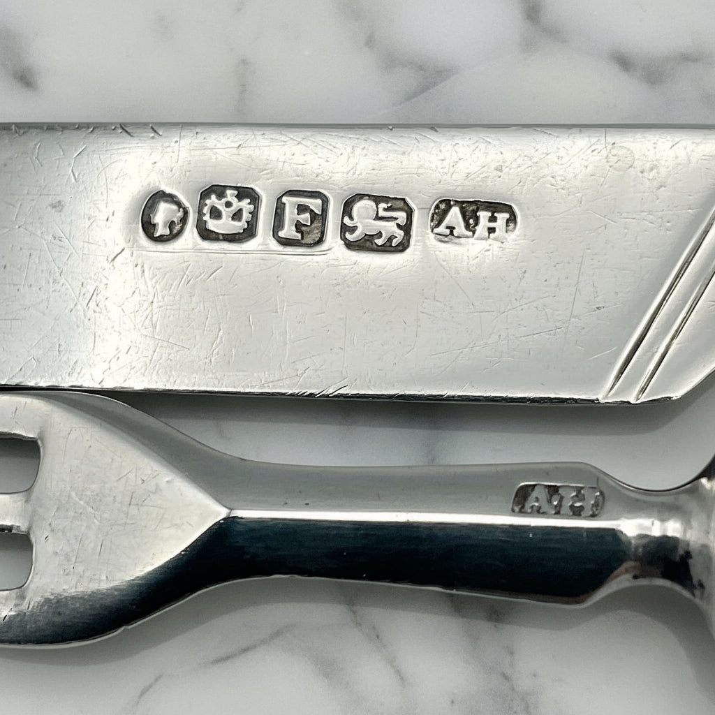hallmarks on silver cultlery on marble background