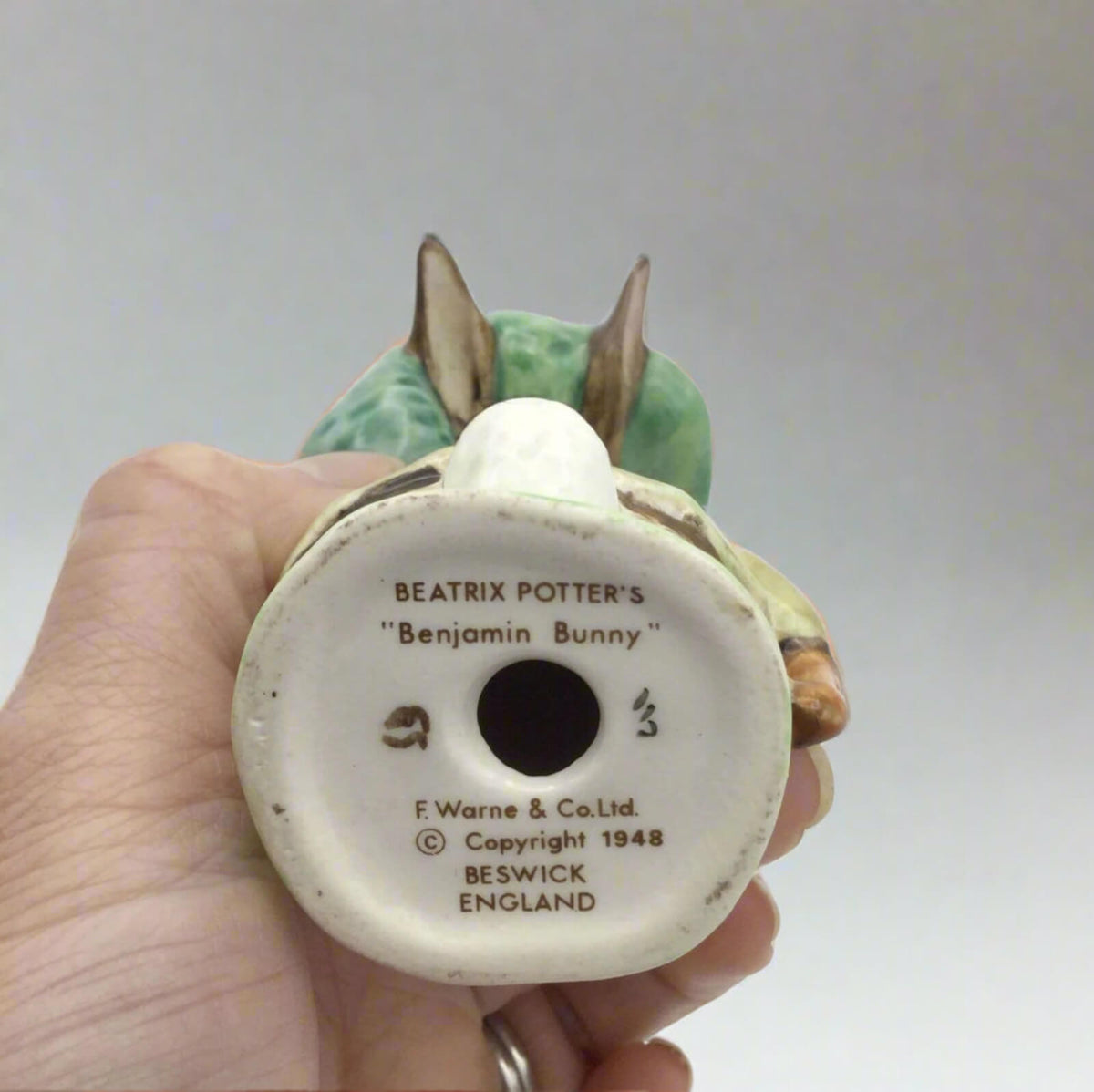Back of a ceramic rabbit figurine with 'Beatrix Potter's Benjamin Bunny' branding.