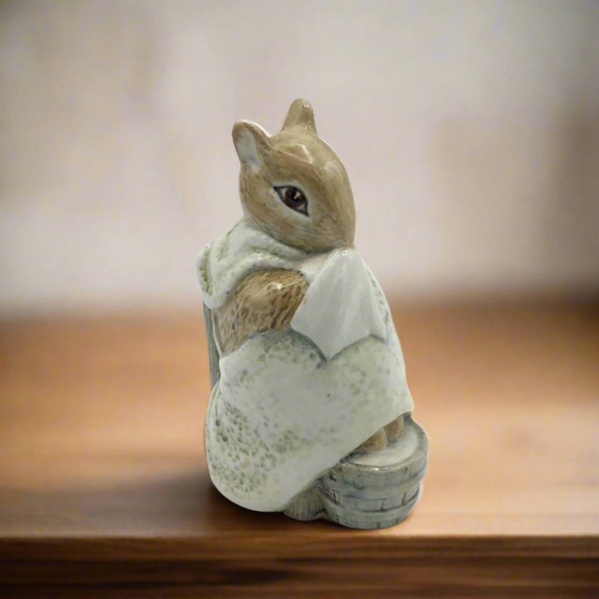 Ceramic figurine of chippy hackee on a wooden surface with a blurred background