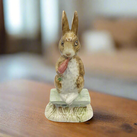 Decorative rabbit figurine on a wooden surface with a blurred background