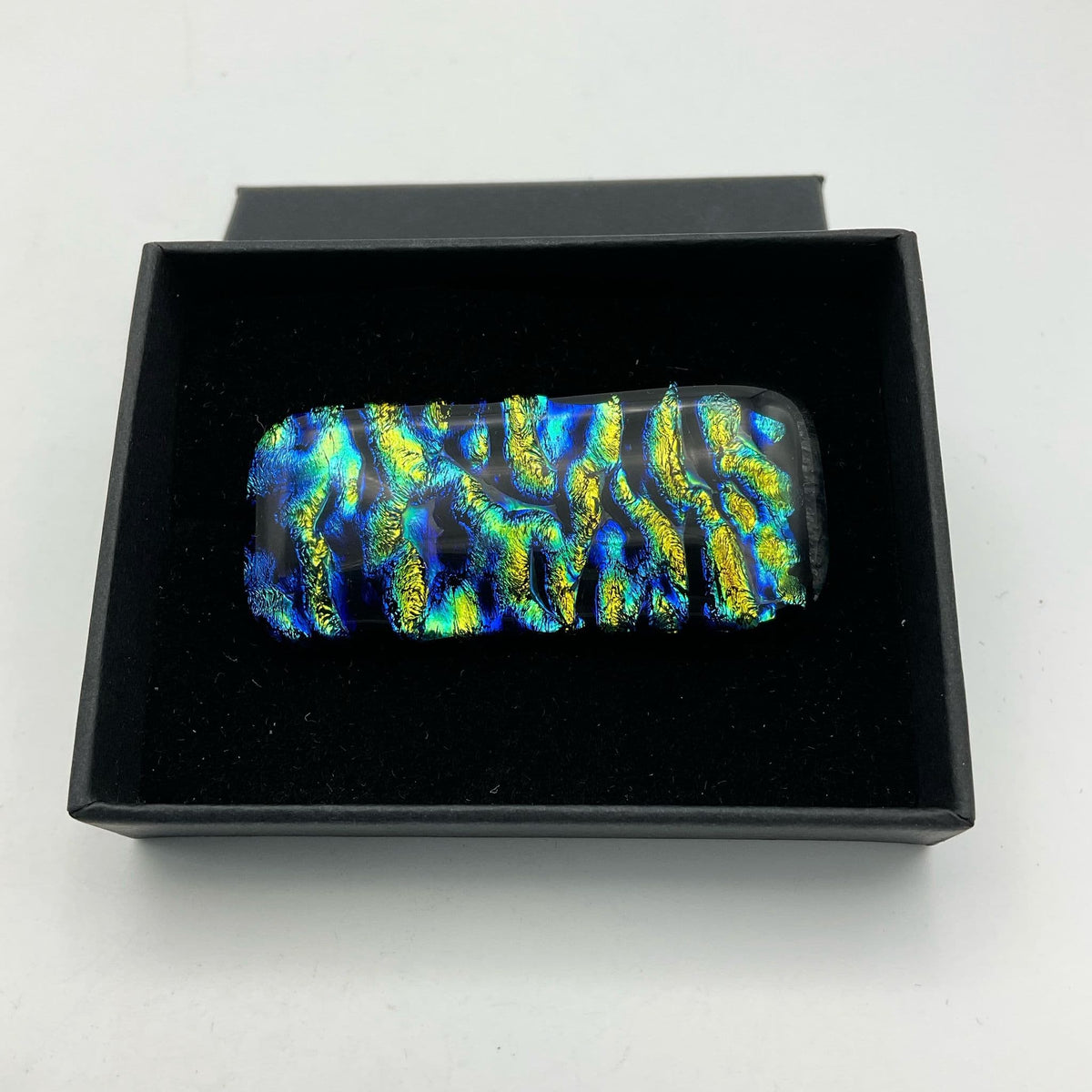 Blue and yellow glass brooch by Beeches Vintage featuring a vibrant, handcrafted design with polished glass accents.