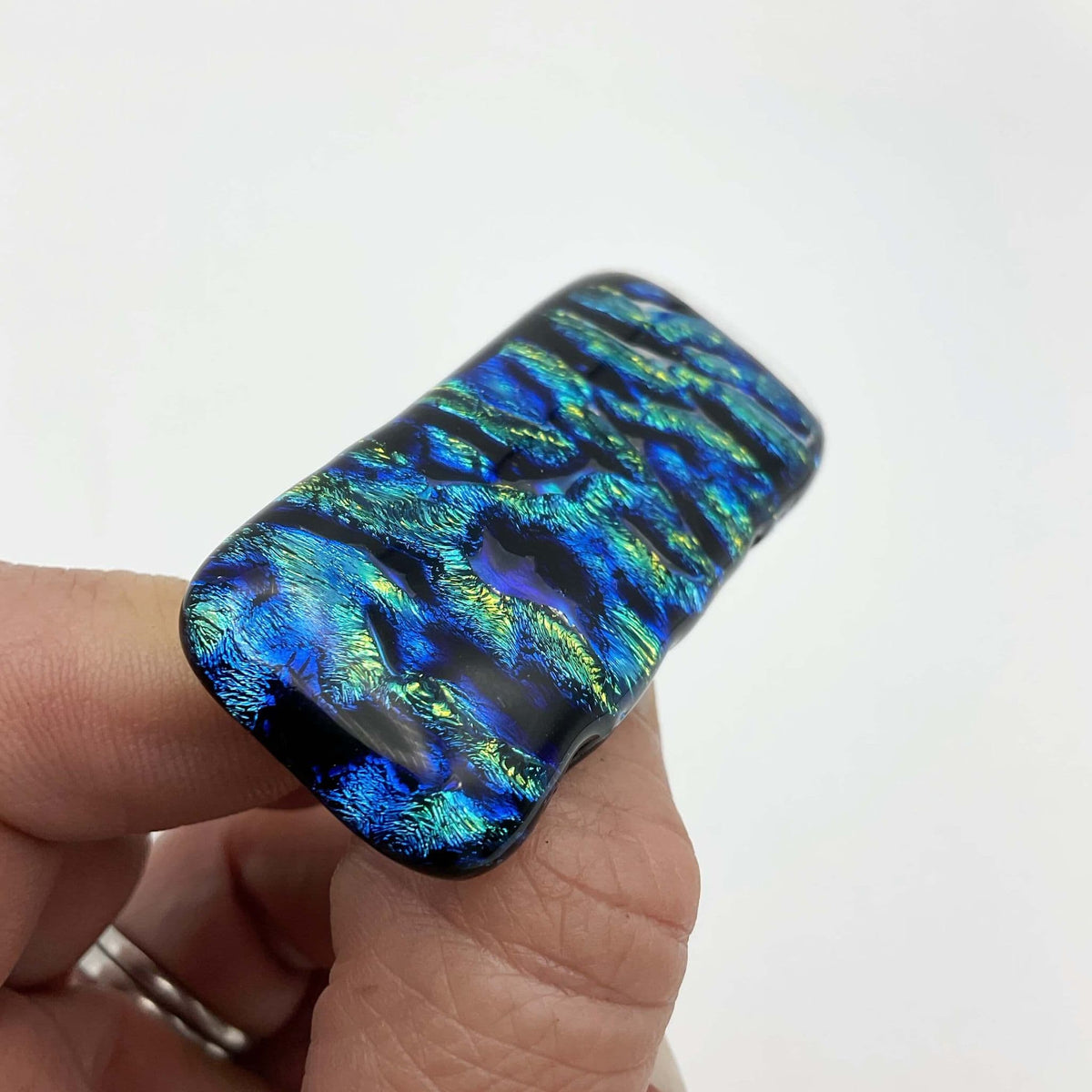 Blue and yellow glass brooch by Beeches Vintage featuring a vibrant, handcrafted jewelry piece with intricate glass design.