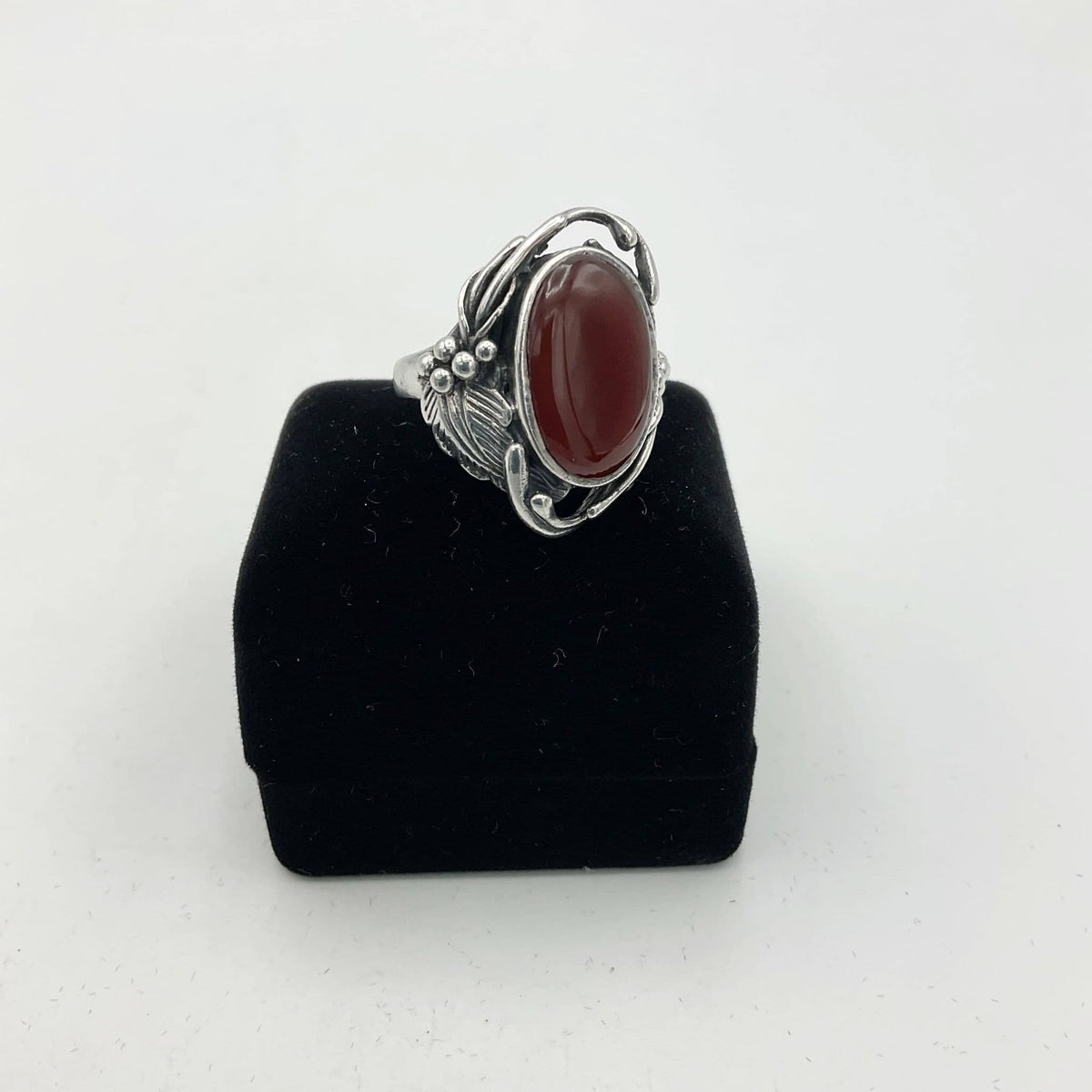 Beautiful orange Carnelian gemstone silver ring sitting on black presentation box