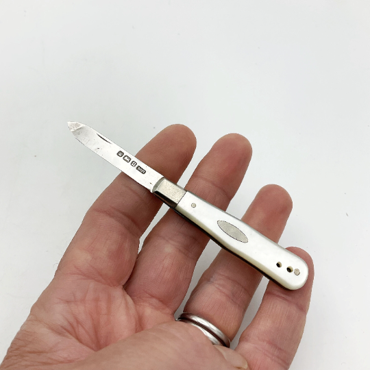 Antique sterling silver fruit knife with 1912 hallmarks, displayed on a wooden surface, from Beeches Vintage collection.