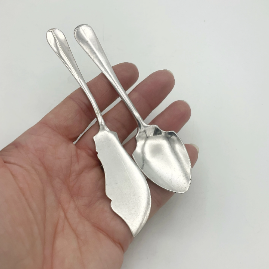 Beeches Vintage 1930s Mappin & Webb butter knife and jam spoon set, silver-plated cutlery with ornate handles on a white background.