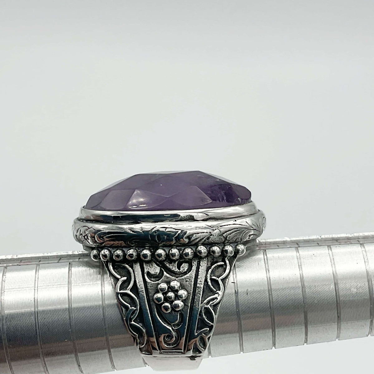 Large purple amethyst sterling silver ring from Beeches Vintage, featuring a polished amethyst gemstone and intricate silver band.