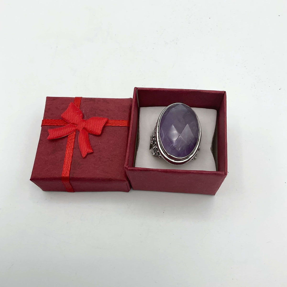 Large purple amethyst sterling silver ring featuring a prominent amethyst gemstone set in a detailed silver band.