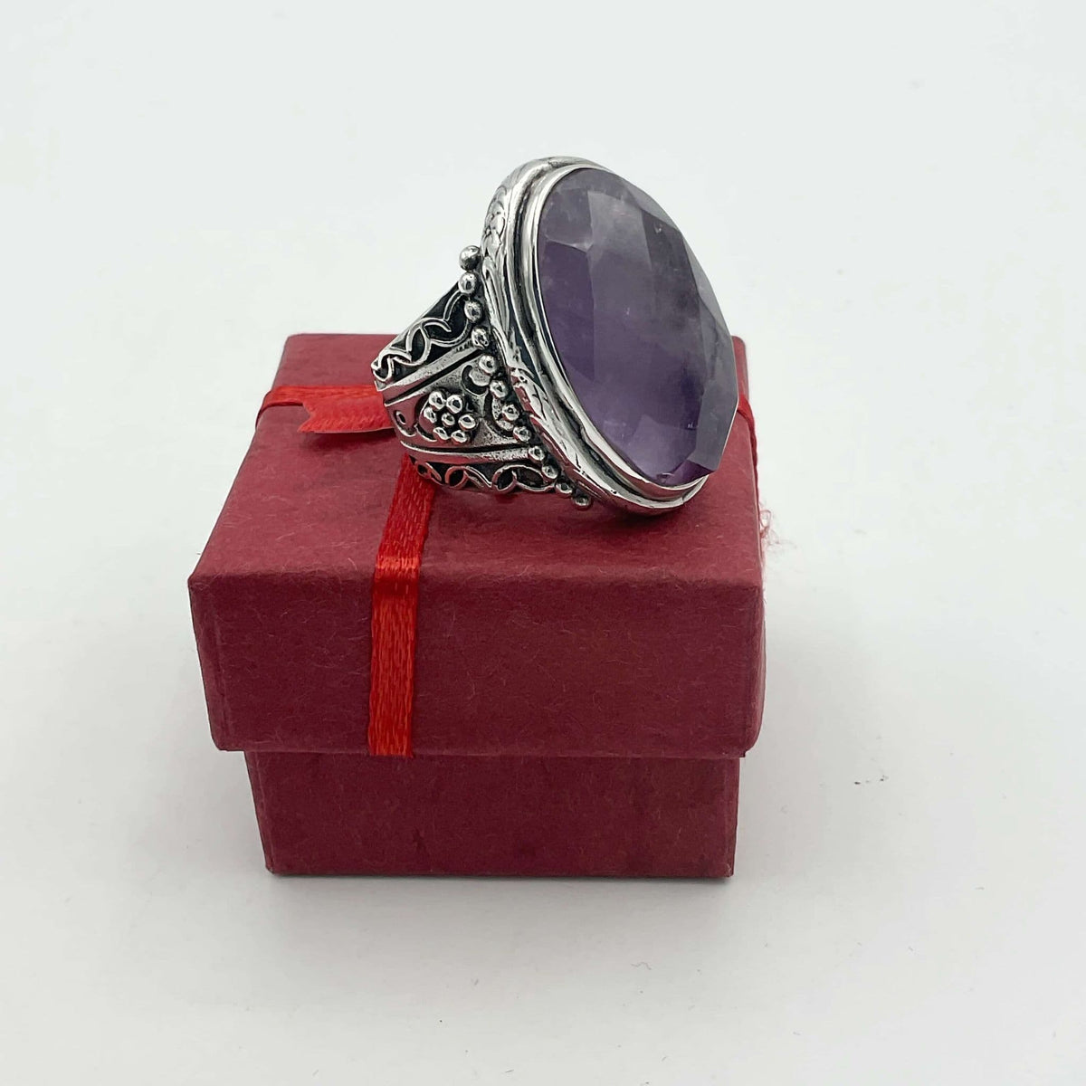 Large purple amethyst sterling silver ring featuring a prominent amethyst gemstone set in a detailed silver band.