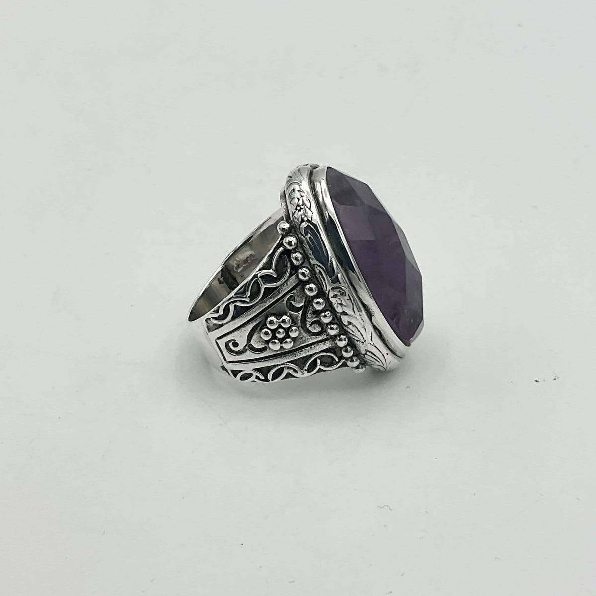 Large purple amethyst sterling silver ring featuring a prominent amethyst gemstone set in a detailed silver band.