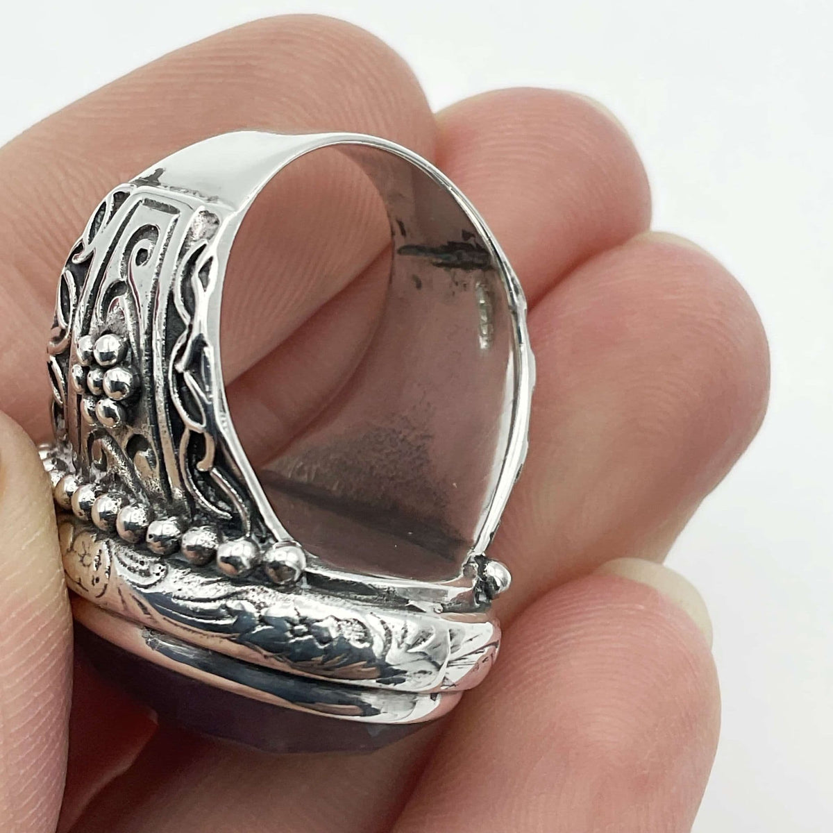 Large purple amethyst sterling silver ring with intricate band design by Beeches Vintage, showcasing a prominent purple gemstone.