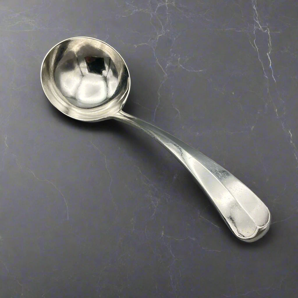 Silver spoon on a gray surface