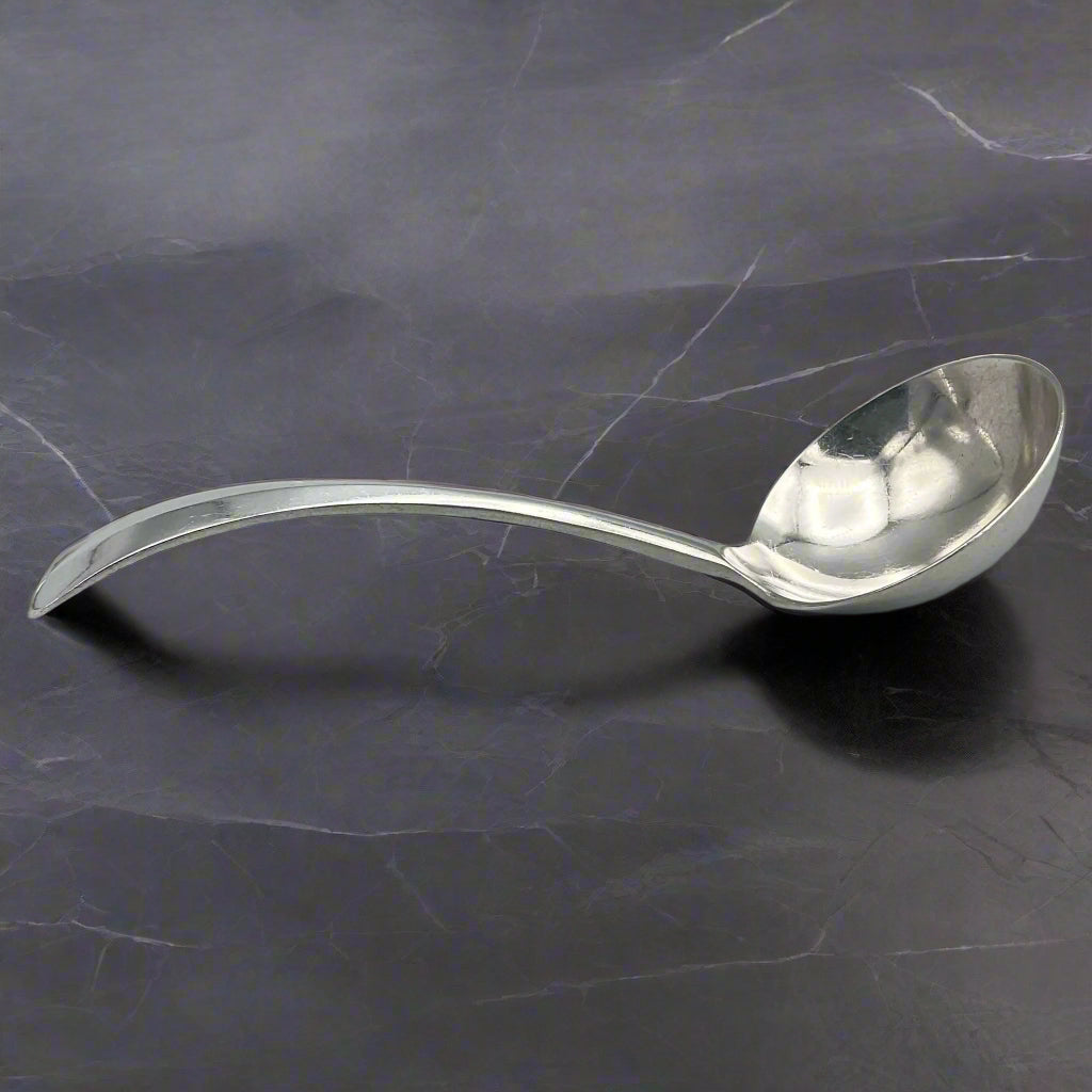 ladle on a dark marble surface