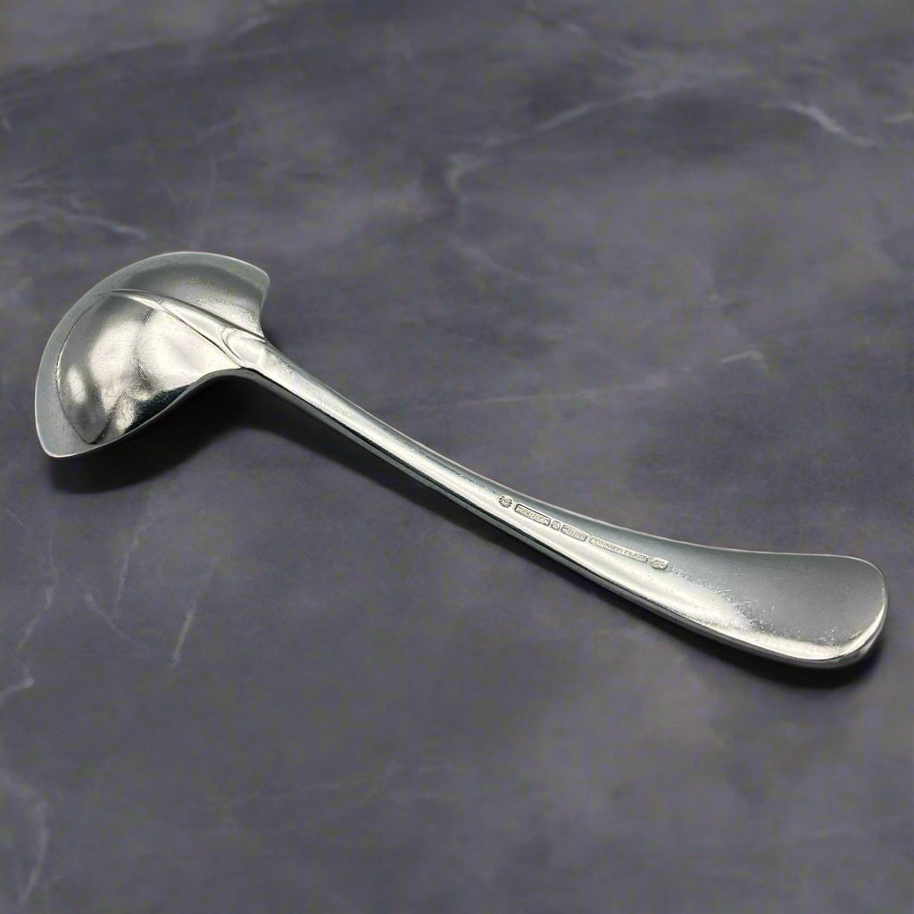 ladle upside down on a dark marble surface