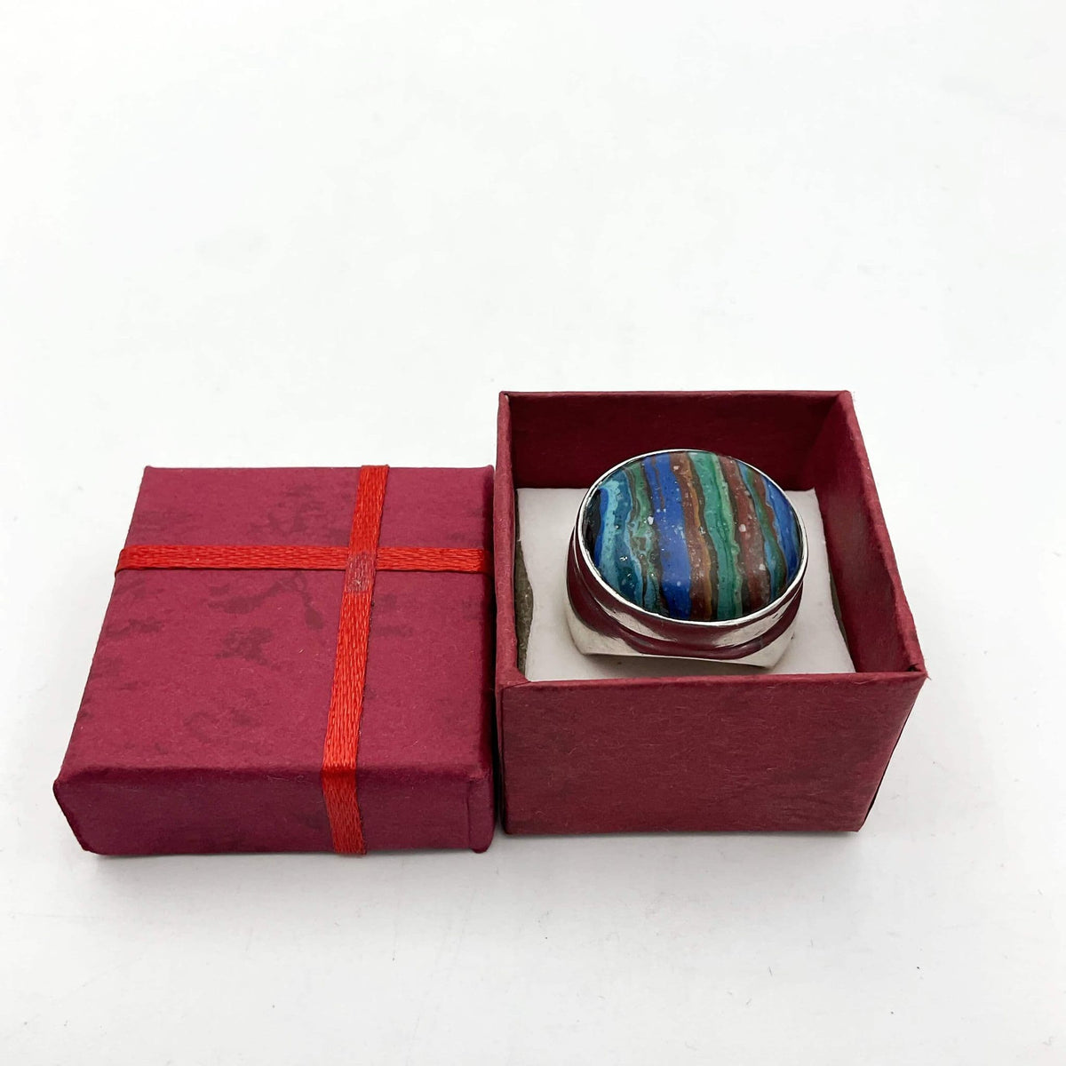Multicoloured Rainbow Calsilica silver ring with a polished band, showcasing vibrant rainbow hues and unique gemstone patterns.