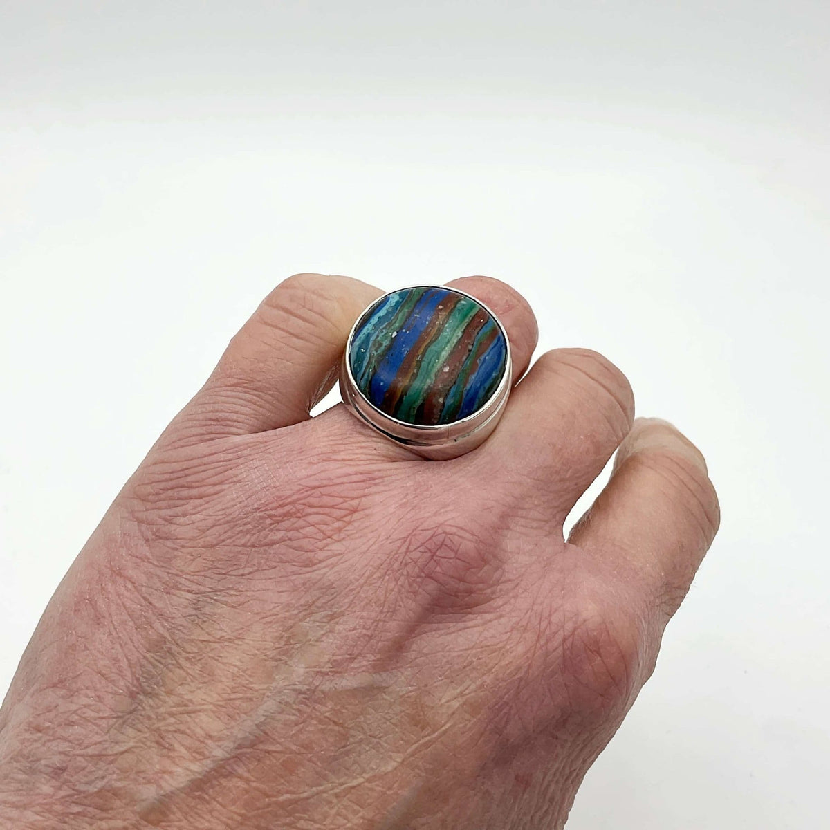 Multicoloured Rainbow Calsilica silver ring featuring vibrant rainbow hues and intricate silver band design.