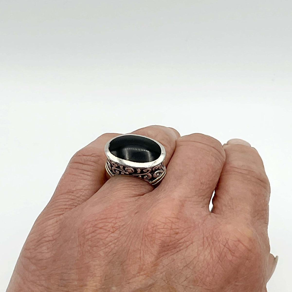 Oval black onyx silver ring by Beeches Vintage, featuring a polished black onyx stone set in a sleek silver band.