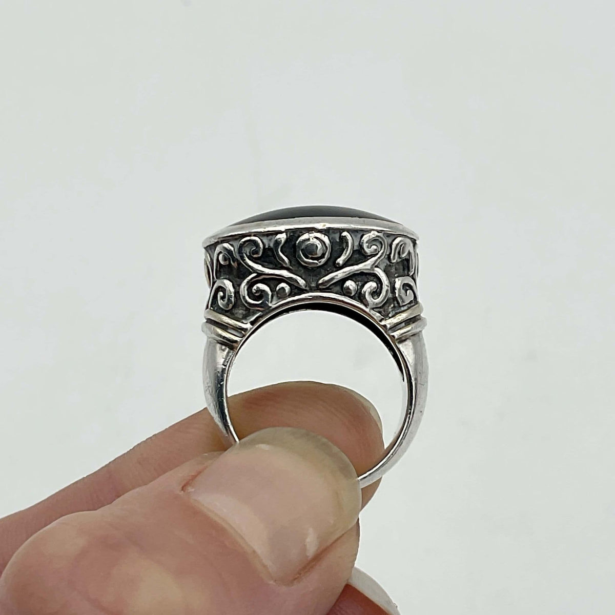 Oval black onyx silver ring by Beeches Vintage featuring a polished black onyx stone set in a silver band.