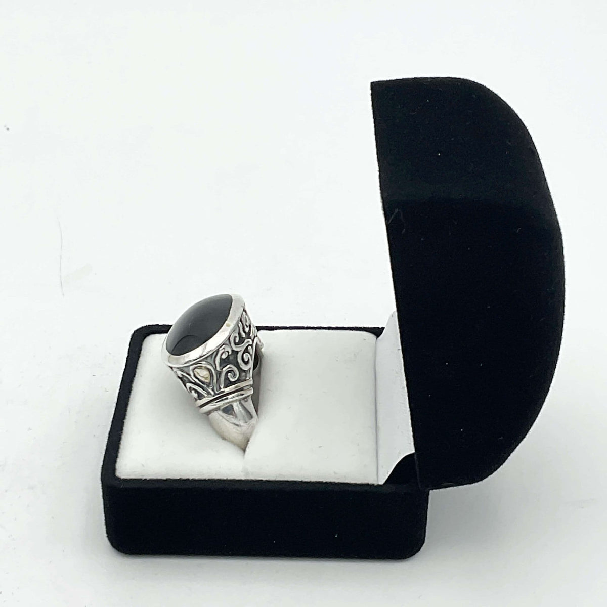 Oval black onyx silver ring with a polished black stone set in a detailed silver band, crafted by Beeches Vintage.