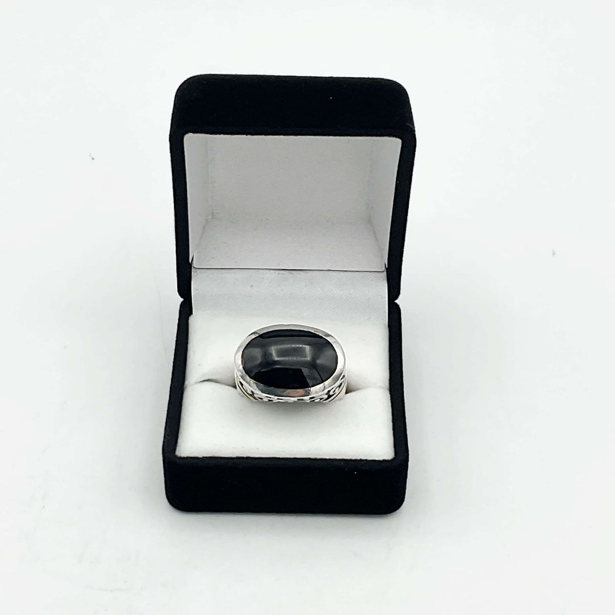 Oval black onyx silver ring featuring a smooth, polished black gemstone set in a sterling silver band by Beeches Vintage.