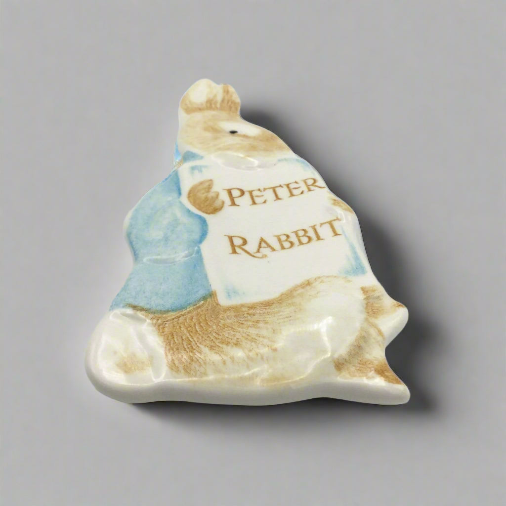 Peter Rabbit plaque lying flat on a grey surface