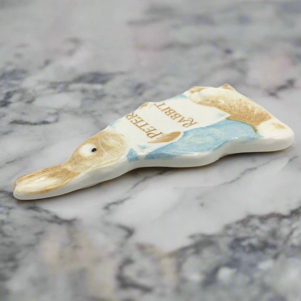 side view of Peter Rabbit plaque on a marble worktop