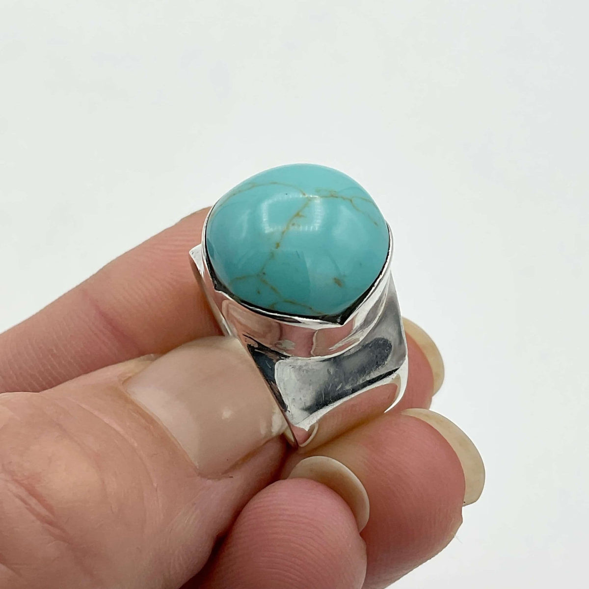 Polished turquoise silver ring by Beeches Vintage featuring a vibrant turquoise stone set in a sleek silver band.