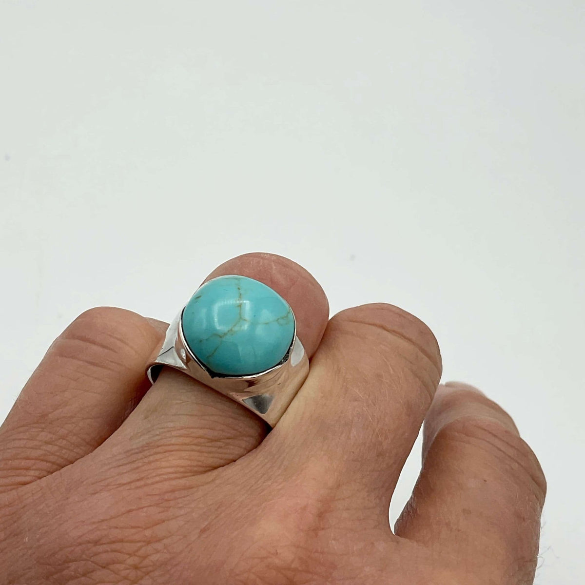 Polished turquoise silver ring by Beeches Vintage featuring a smooth turquoise stone set in a silver band.