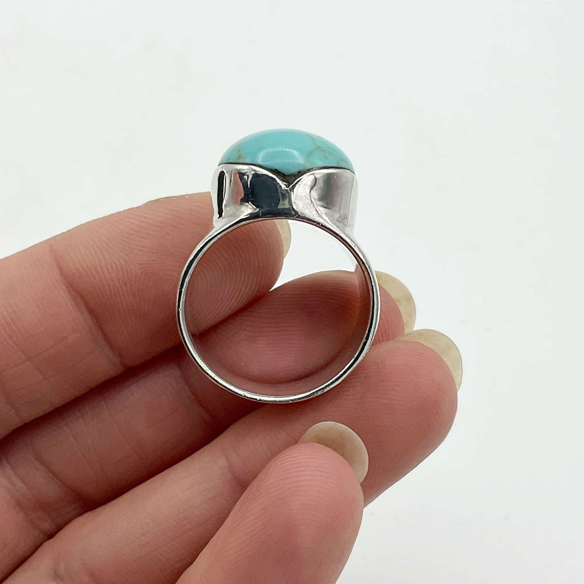 Polished turquoise silver ring by Beeches Vintage featuring a smooth turquoise stone set in a detailed silver band.