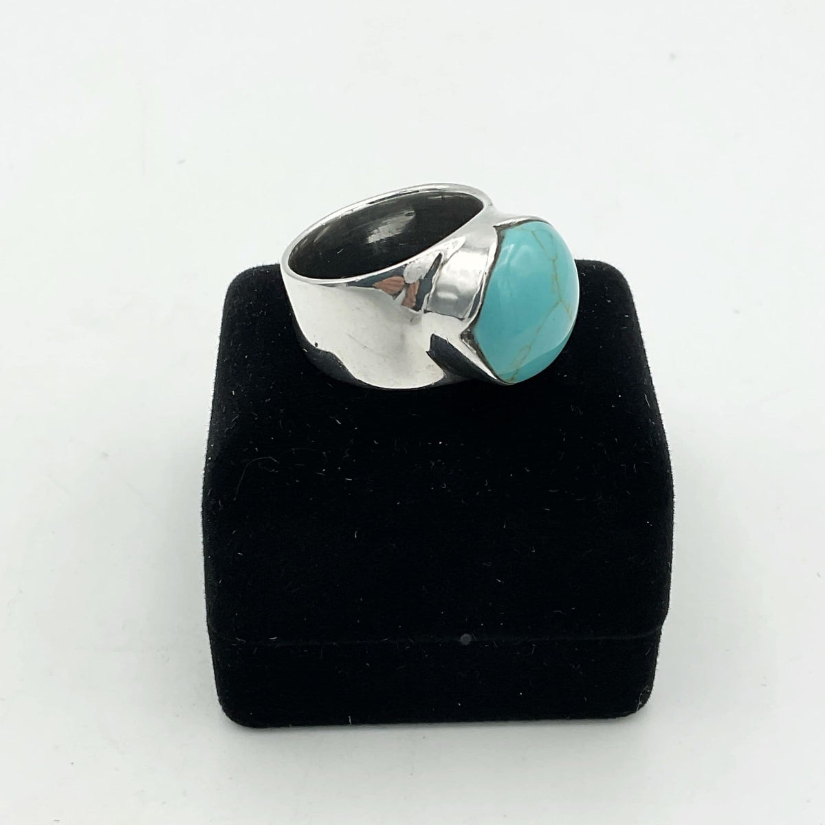 Polished turquoise silver ring by Beeches Vintage featuring a vibrant turquoise stone set in a silver band.