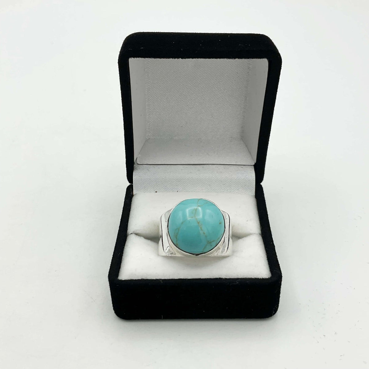 Polished turquoise silver ring with intricate design by Beeches Vintage, showcasing a vibrant turquoise gemstone on a silver band.