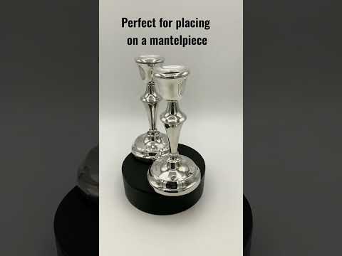 a pair of silver candlesticks on a video short