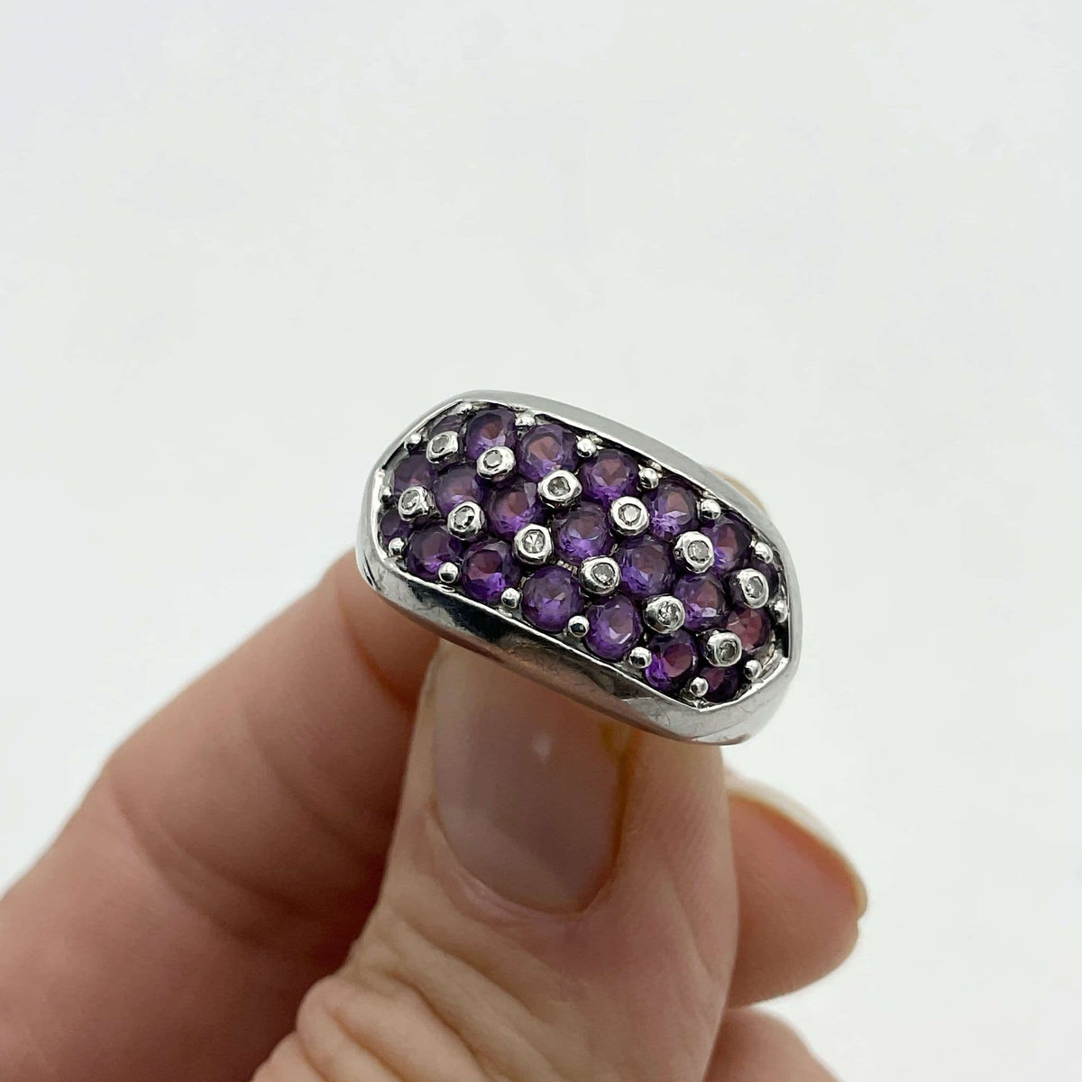Purple Amethyst sterling silver ring featuring a large oval amethyst gemstone set in a detailed band.