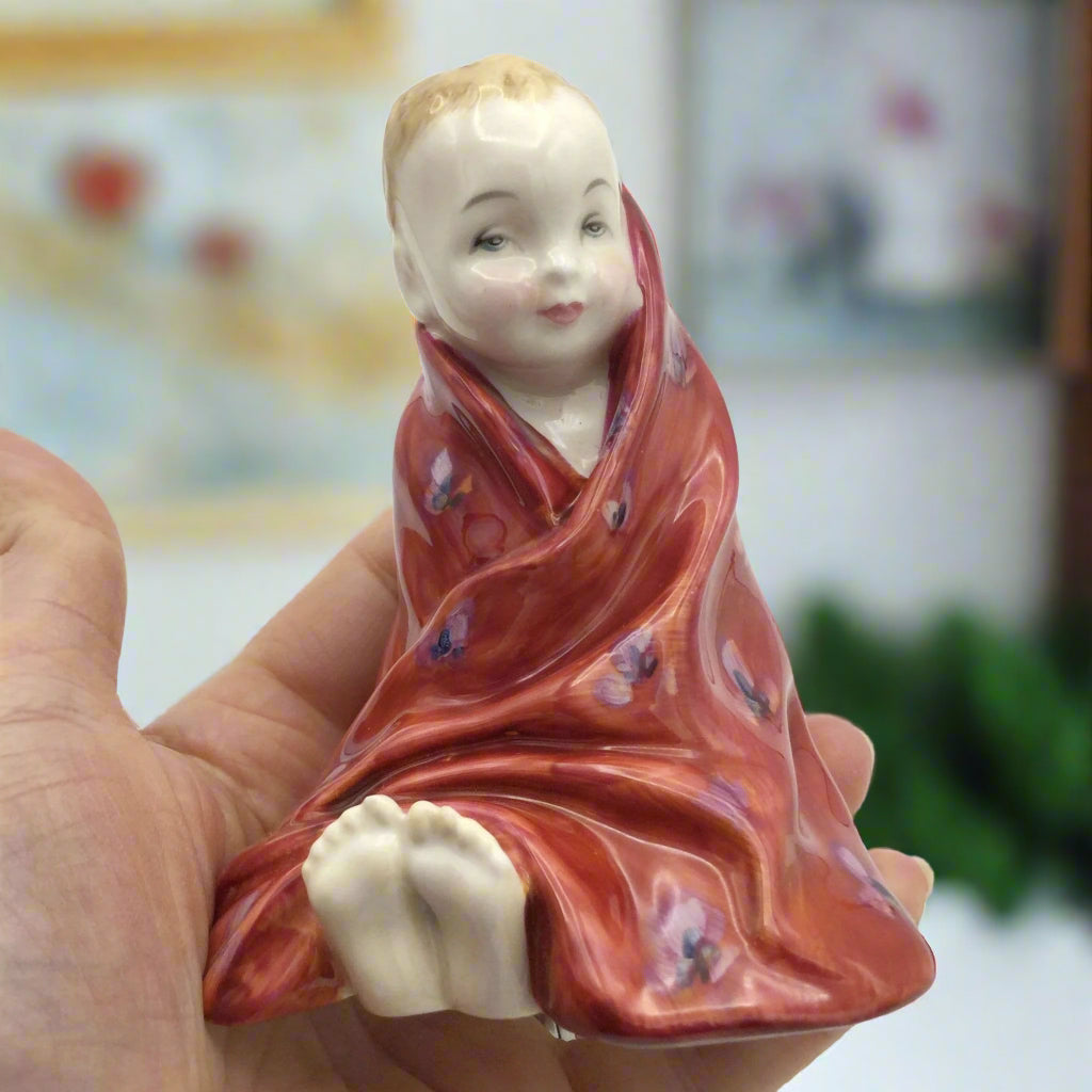 ornament in hand with a room in the background