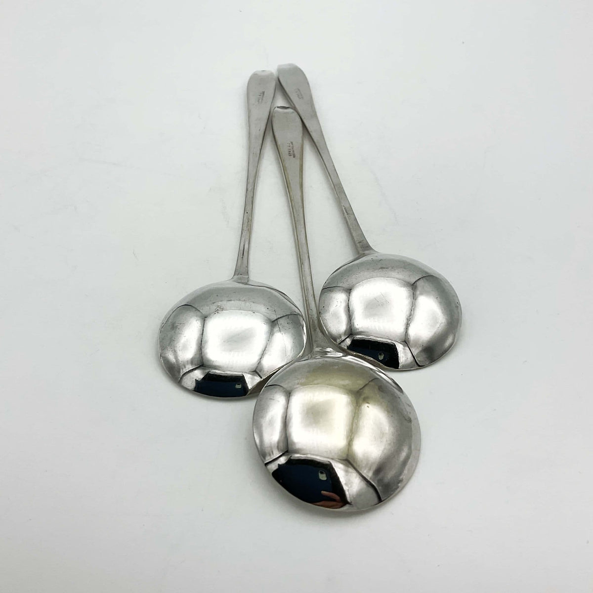 Set of silver-plated long-handled dessert spoons by Beeches Vintage, showcasing elegant, reflective silver finish and intricate handle design.