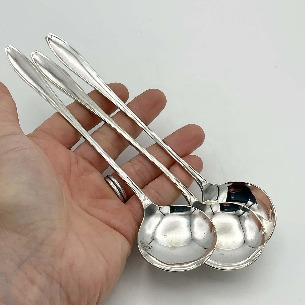 Set of three silver-plated long-handled dessert spoons by Beeches Vintage, showcasing elegant vintage design and shiny finish.