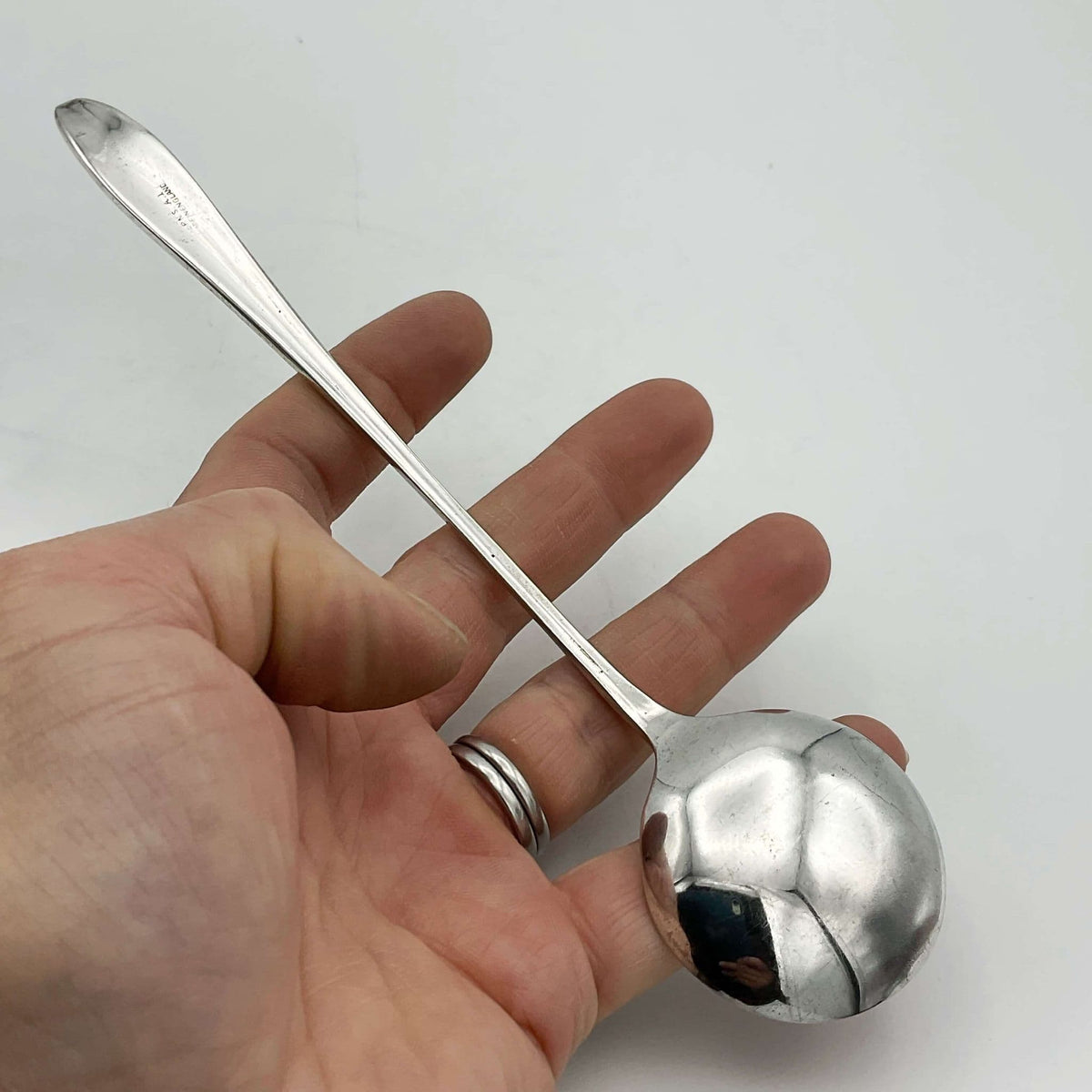 Set of silver-plated long-handled dessert spoons from Beeches Vintage, showcasing elegant, shiny silverware with ornate handles.