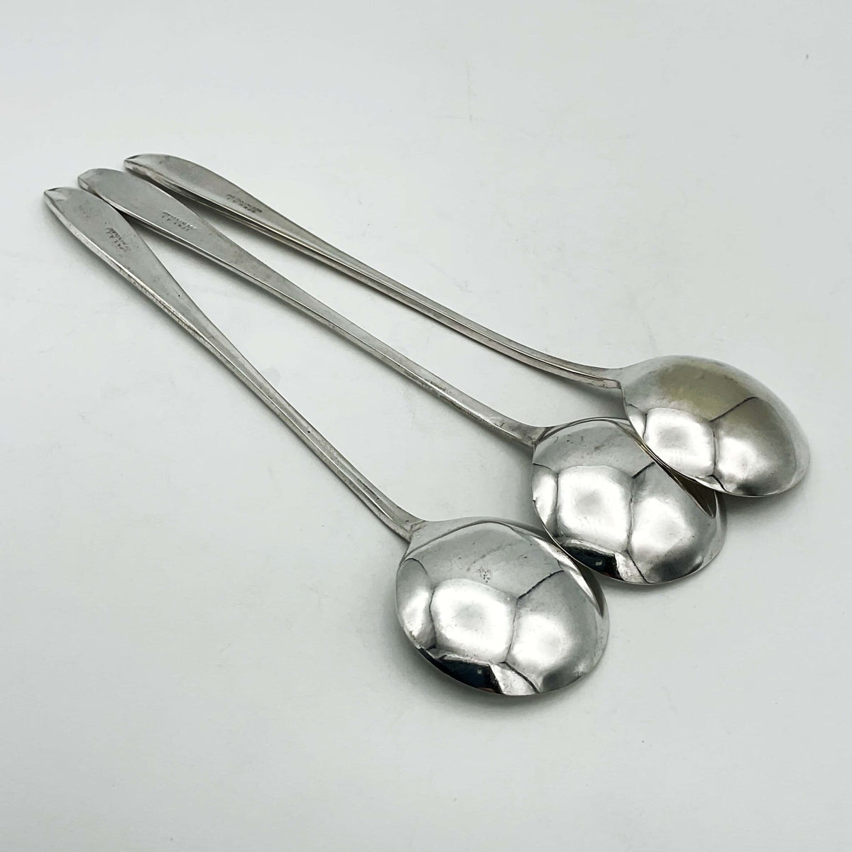 Set of six silver-plated long-handled dessert spoons from Beeches Vintage, featuring elegant vintage design and polished finish.