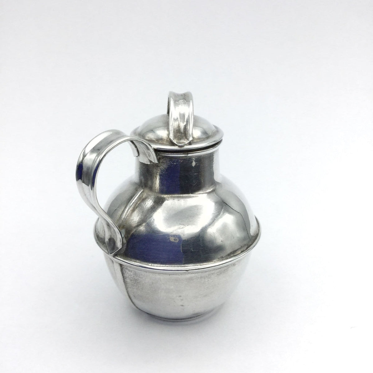 silver plated jug urn on a plain background
