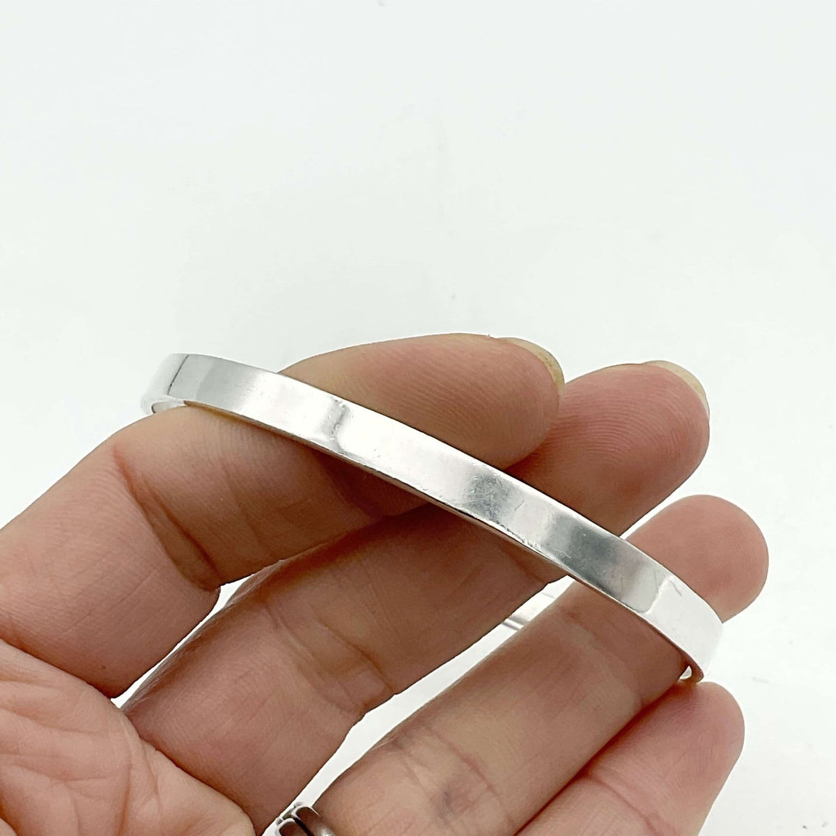 Solid sterling silver bangle bracelet by Beeches Vintage, featuring a smooth, polished finish and classic circular design.