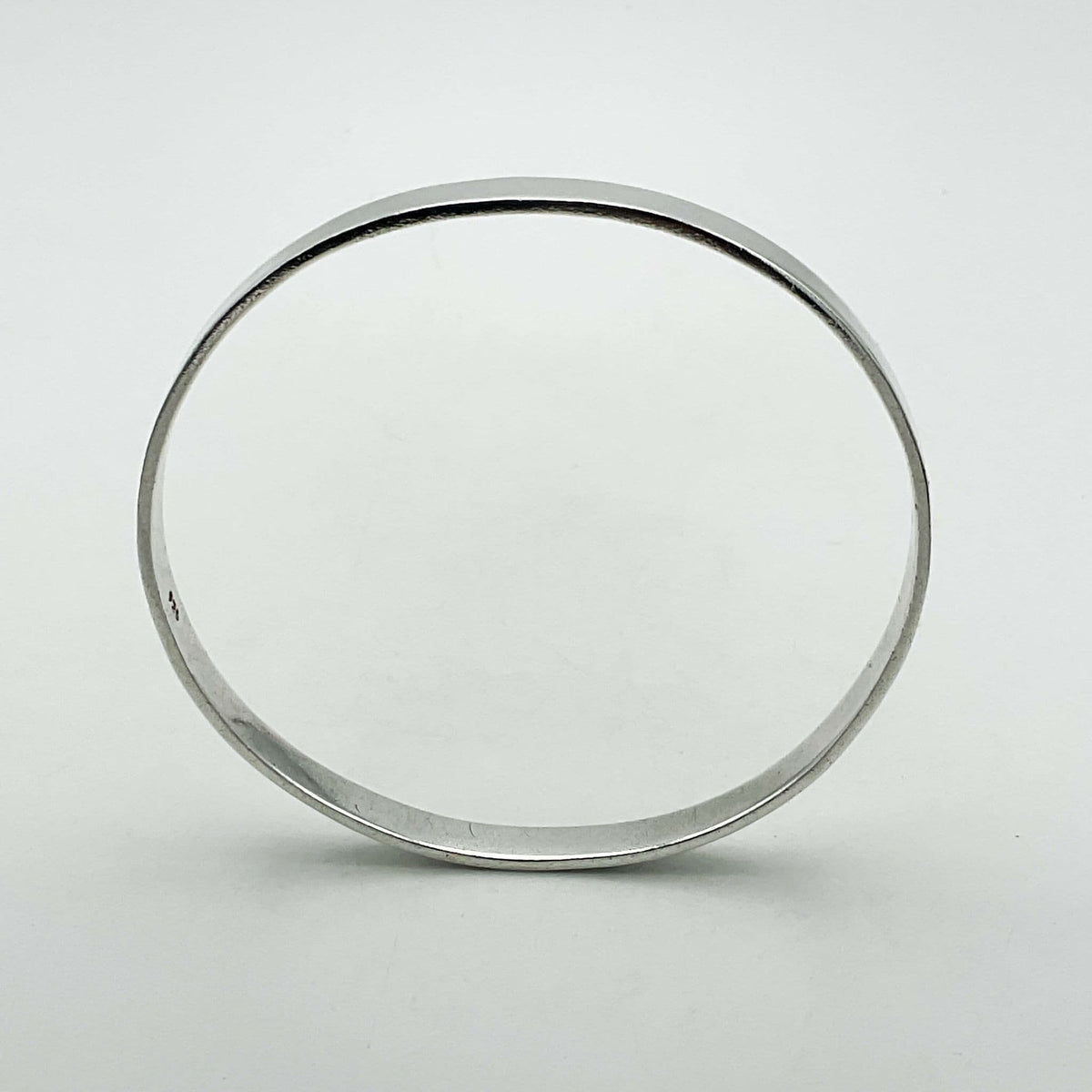 Sterling silver bangle bracelet from Beeches Vintage with a smooth, polished finish, designed for stylish wrist wear.