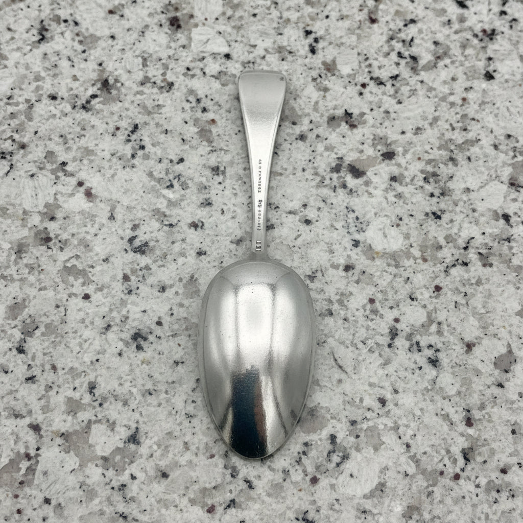 Silver spoon on a textured granite background