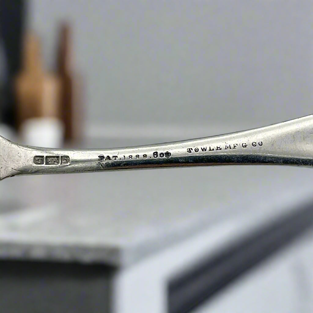 back of spoon showing Towle Manufacturing with a marble worktop in the background