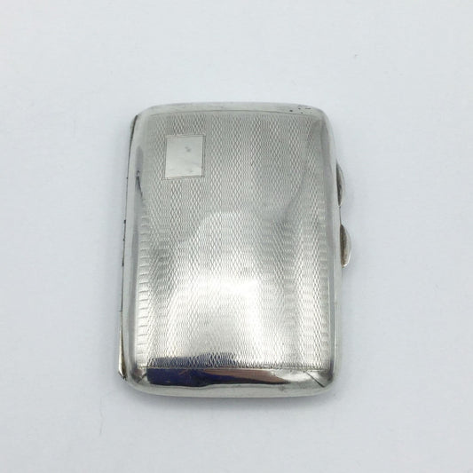 a shiny vintage art deco style sivler cigarette case on a white background