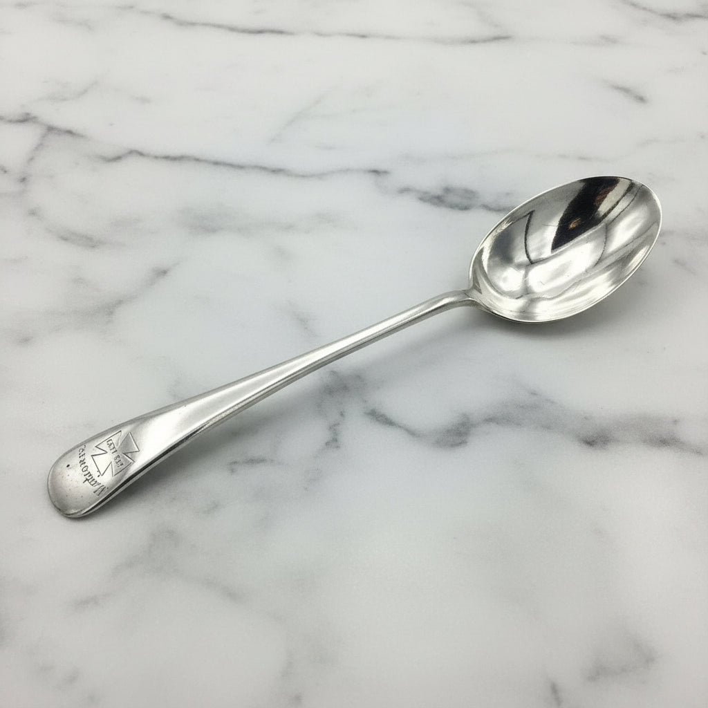 Antique Silver plated spoon with Marjorie on the handle on a marble surface