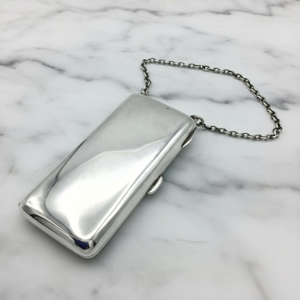 Shiny Silver case with chatelaine chain on marble background