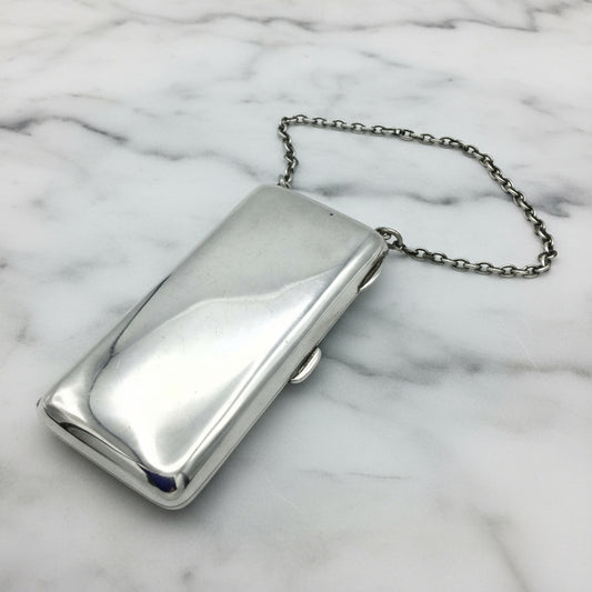 Shiny Silver case with chatelaine chain on marble background