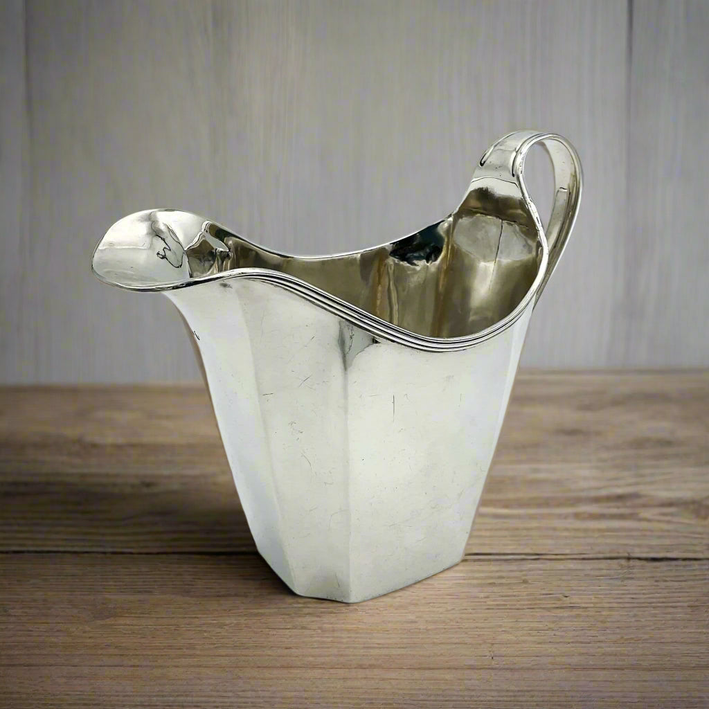 Silver milk jug on  wood table