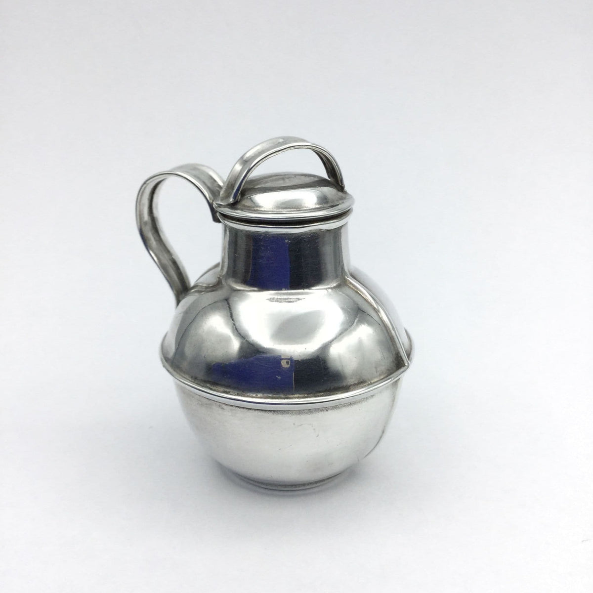 silver plated jug urn on a plain background