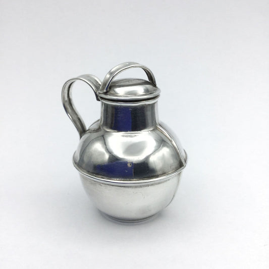 silver plated jug urn on a plain background
